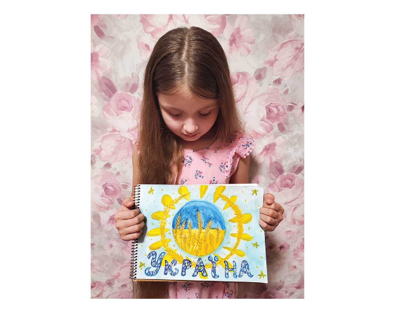 Zlata with artwork she created for members of the Ukrainian military. Students in her school in Ukraine sent artwork and gifts to members of the military to show their support.